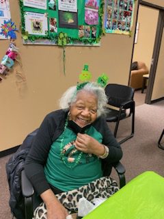 Senior Woman Sitting in Chair and Smilling